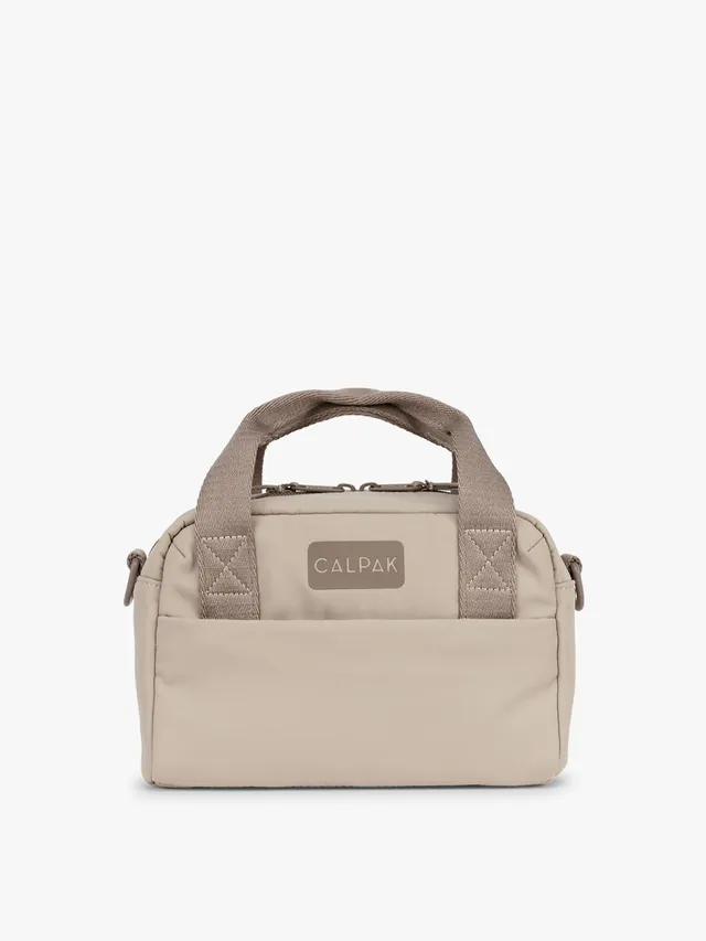 calpak-connect-crossbody-bag-compact-travel-crossbody-with-trolley-sleeve-and-fr image 1